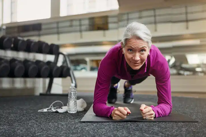 over fifties woman doing pushups